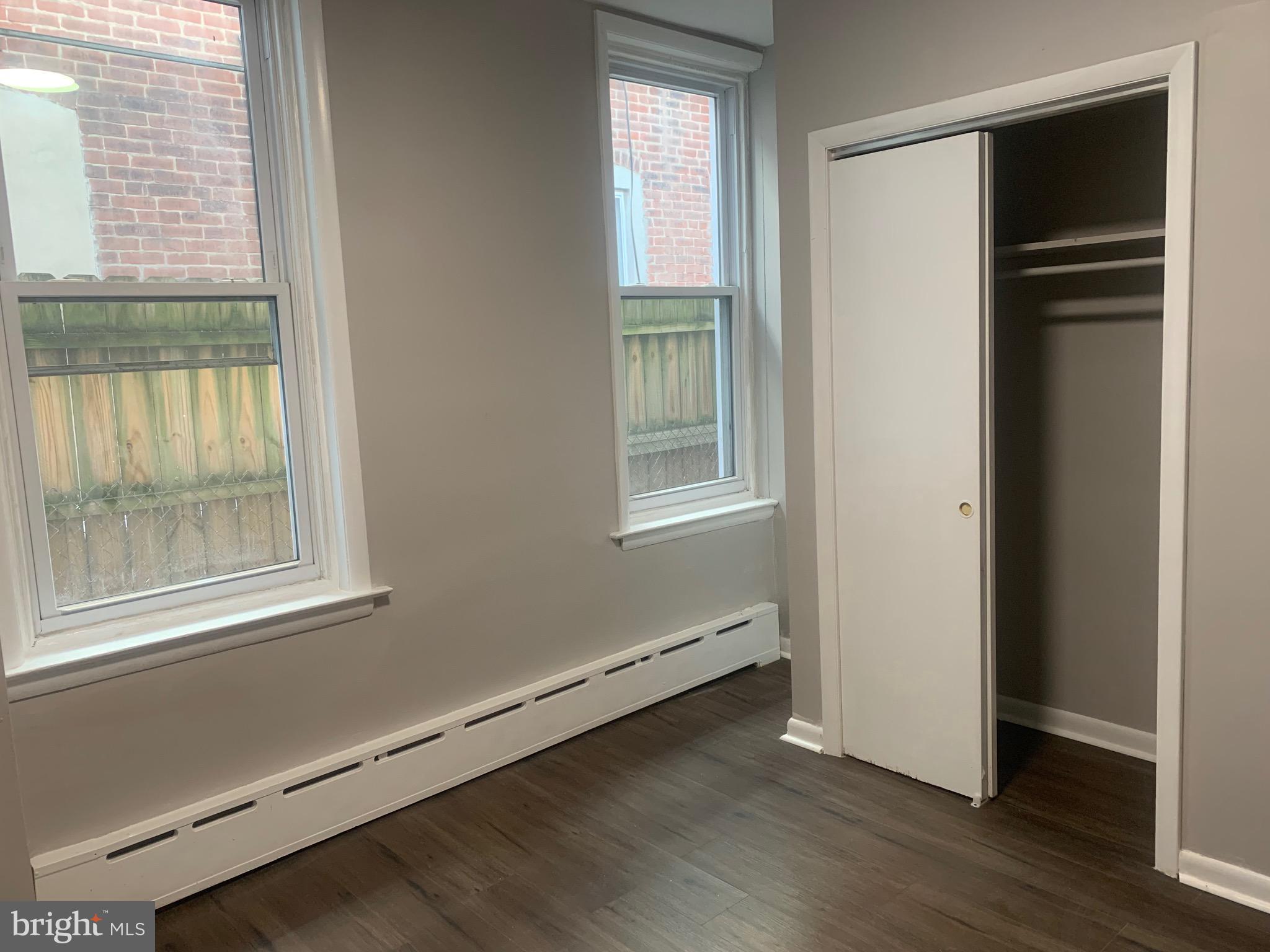 2387 Orthodox Street Philadelphia, PA 19137 - Photo 7 of 13 an empty room with wooden floor and windows