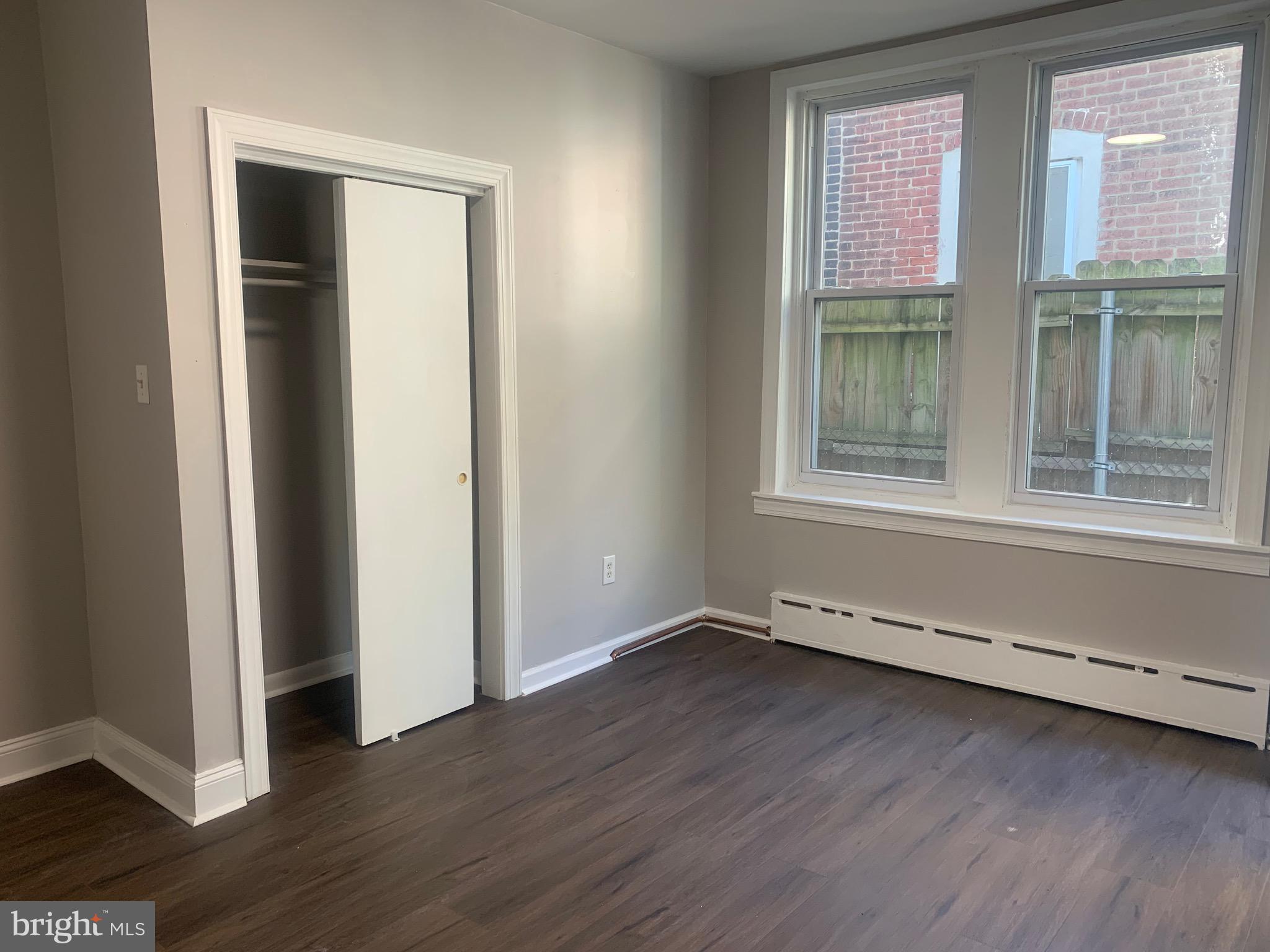 2387 Orthodox Street Philadelphia, PA 19137 - Photo 10 of 13 an empty room with wooden floor and windows