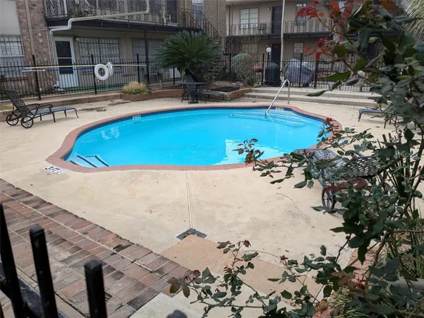a view of a swimming pool with a patio