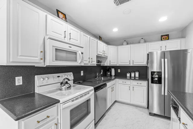 a kitchen with a sink a stove and refrigerator
