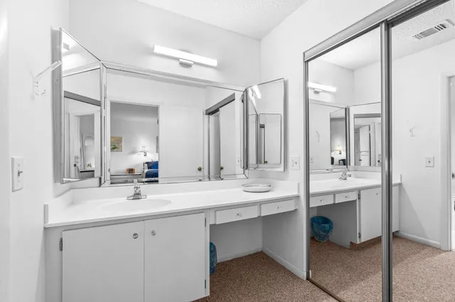 a bathroom with a double vanity sink mirror and double