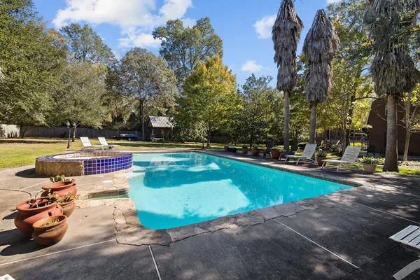 a view of a swimming pool with a yard