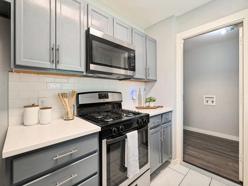 1405 Rambler Road Arlington, TX 76014 - Photo 14 of 26 Kitchen featuring light gray cabinetry with brushed nickel hardware, white countertops, and a white subway tile backsplash