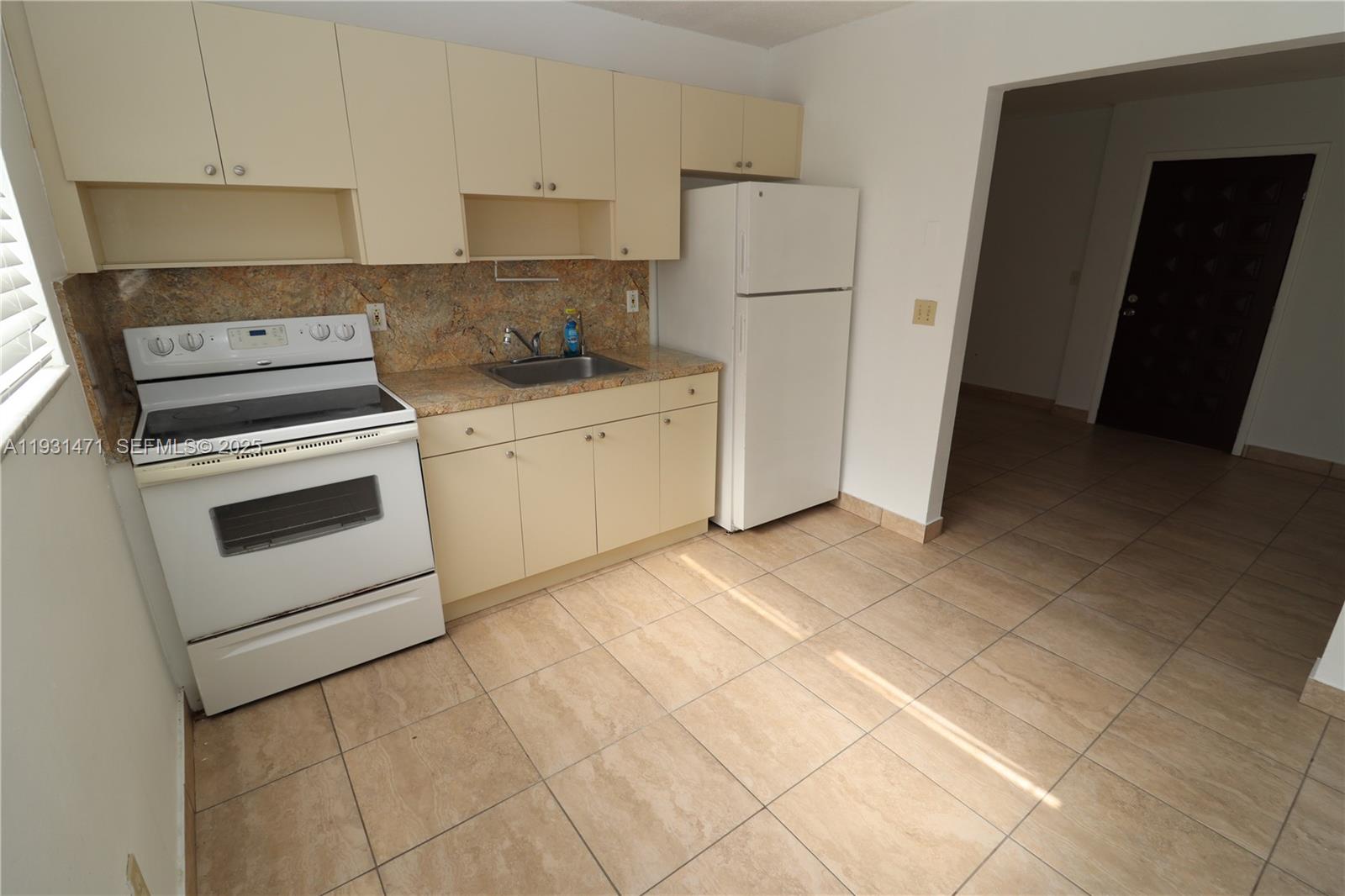 a kitchen with cabinets and white appliances
