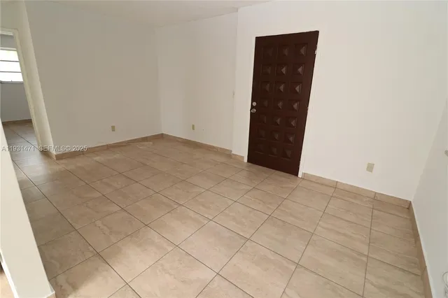 a view of an empty room and staircase