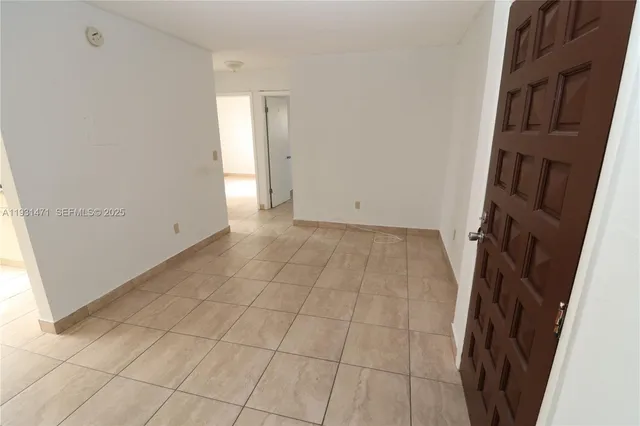 a view of a kitchen space with wooden floor and cabinets