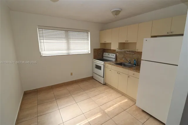 a kitchen with stainless steel appliances a refrigerator sink and microwave