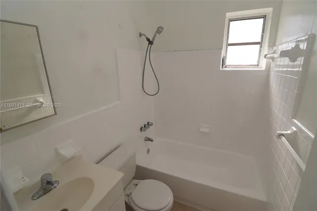a bathroom with a toilet sink and shower