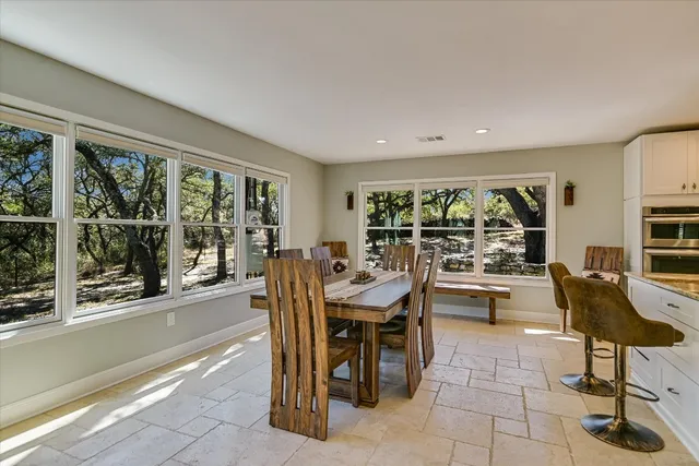 a view of a dining room with furniture wooden floor and chandelier