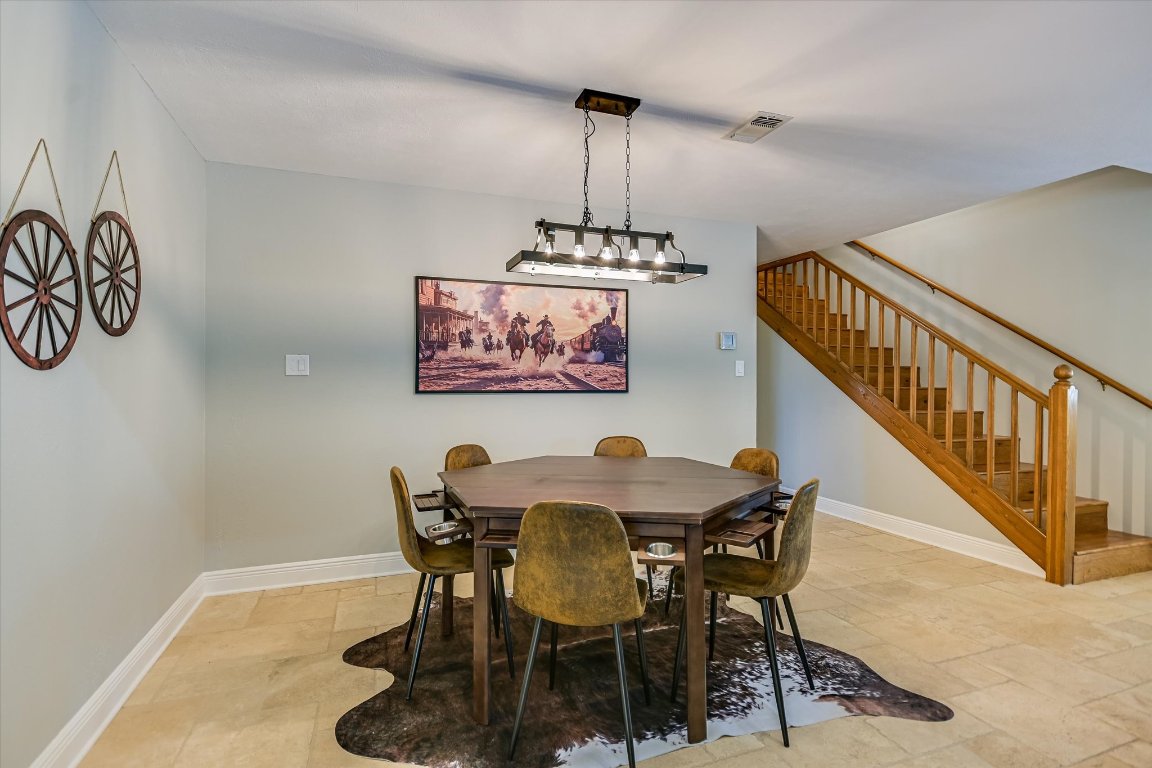 878 Ranch Road 2766 Johnson City, TX 78636 - Photo 13 of 40 a view of a dining room with furniture wooden floor and chandelier