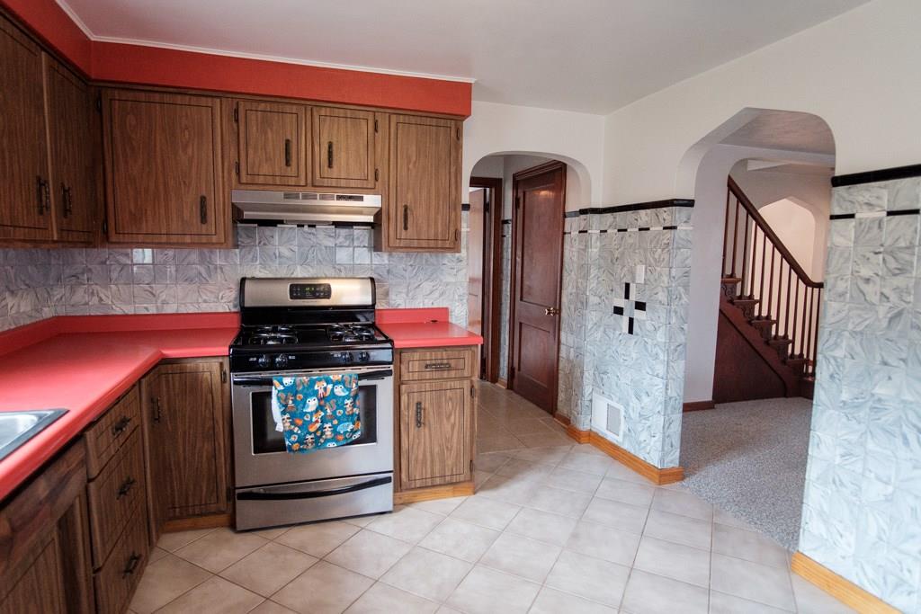 162 Patterson Road Finleyville, PA 15332 - Photo 10 of 25 The kitchen has tile flooring. The hallway leads tothe master bedroom, main level bath and thevisible door on the right side leads to the basement
