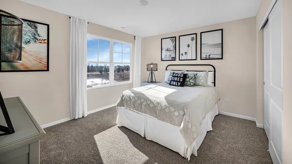 a bedroom with a large bed and a painting on the wall