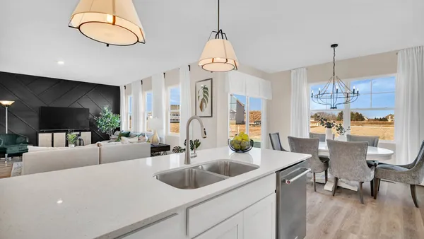 a view of a dining room with furniture wooden floor and chandelier