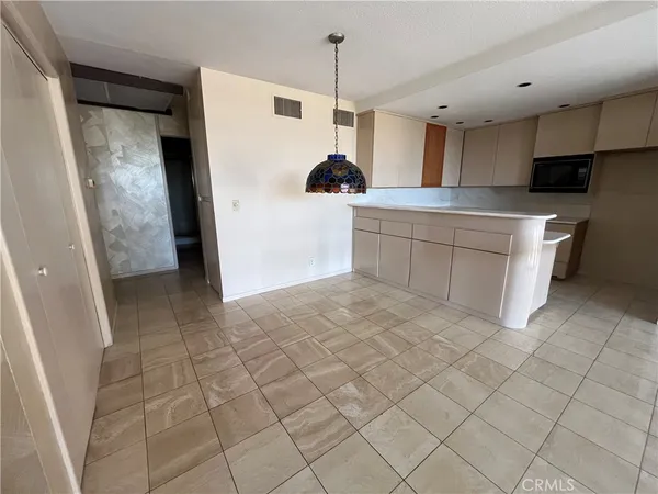 a kitchen with a sink a refrigerator and cabinets