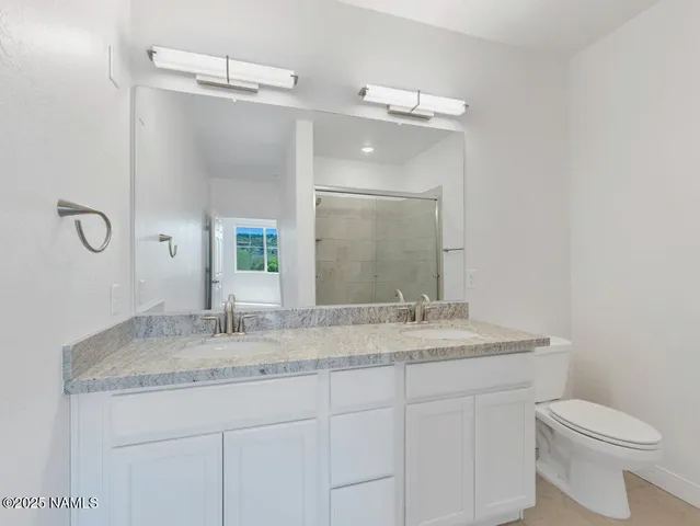 a view of an empty room with window and bathroom