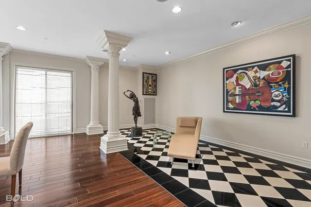 a view of a livingroom with wooden floor and a black white checkered floor