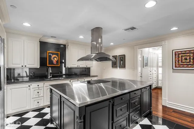 a kitchen with a sink a counter space cabinets and stainless steel appliances