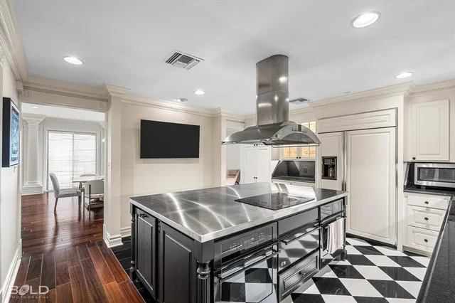 a kitchen with stainless steel appliances kitchen island granite countertop a stove a sink and a microwave