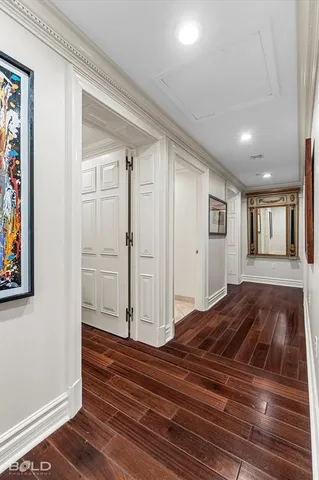 a bedroom with a large bed and a painting on the wall