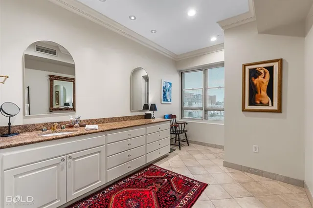 a spacious bathroom with a granite countertop sink and a mirror