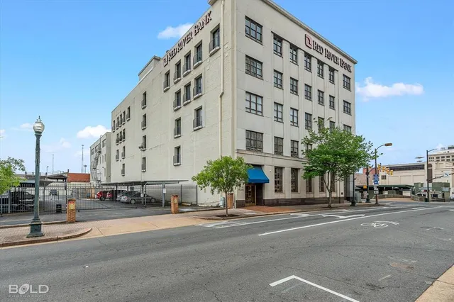 a view of a house with a yard and large tree