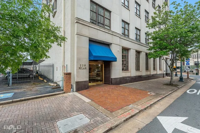 a lobby with furniture and potted plant