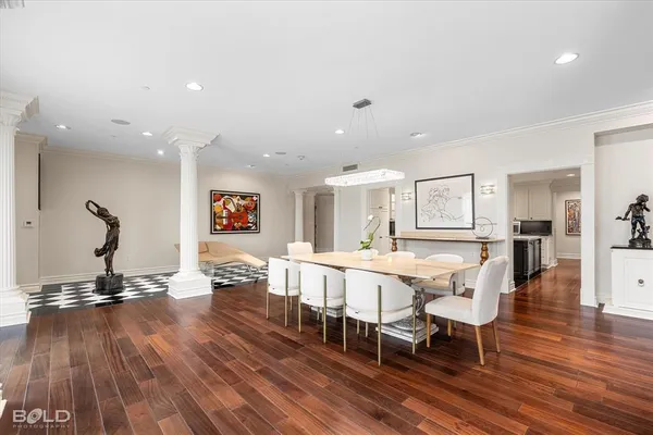 a view of a dining room with furniture wooden floor and chandelier