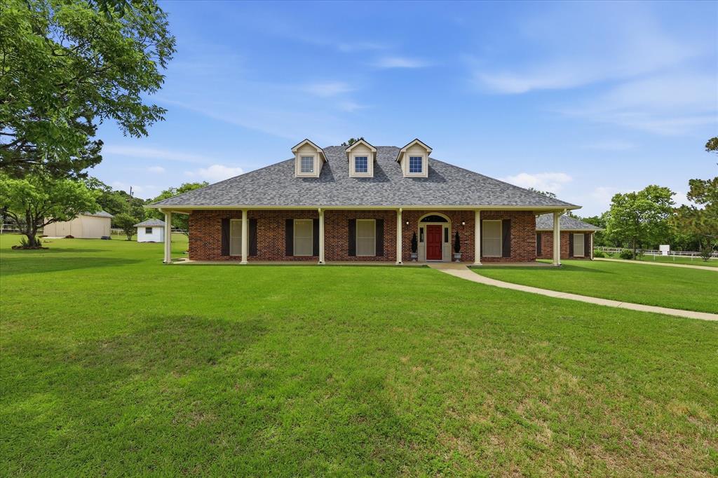 6955 Hawk Road Flower Mound, TX 75022 - Photo 40 of 40 Brick exterior with a gray shingle roof and three dormer windows