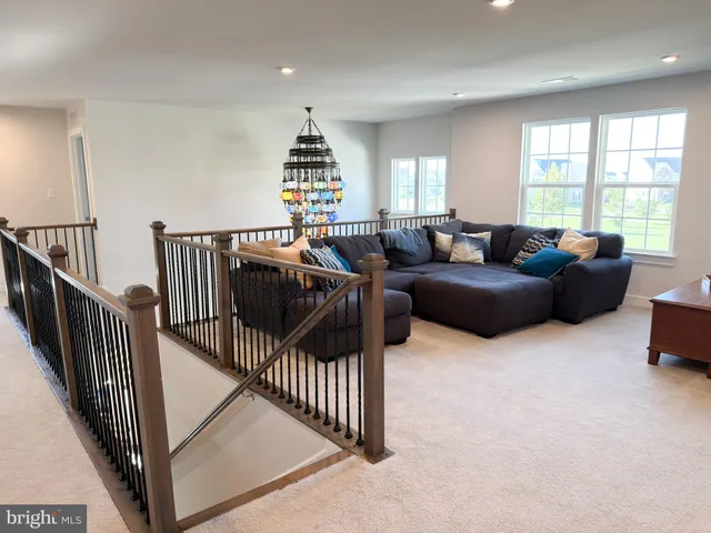 a bedroom with a bed and a large mirror next to a window