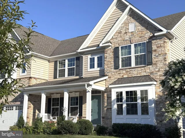 front view of a brick building with a yard