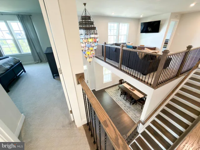 a view of walk in closet with water heater and stairs