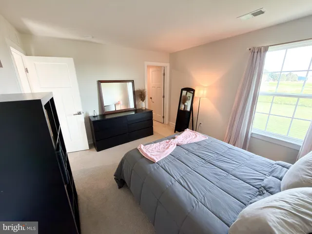 a bedroom with a bed and a potted plant