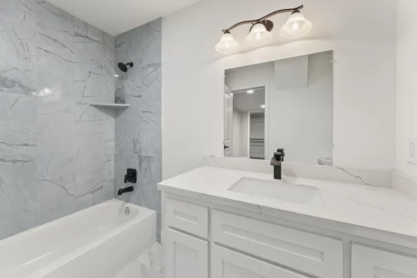 an empty room with wooden floor and window