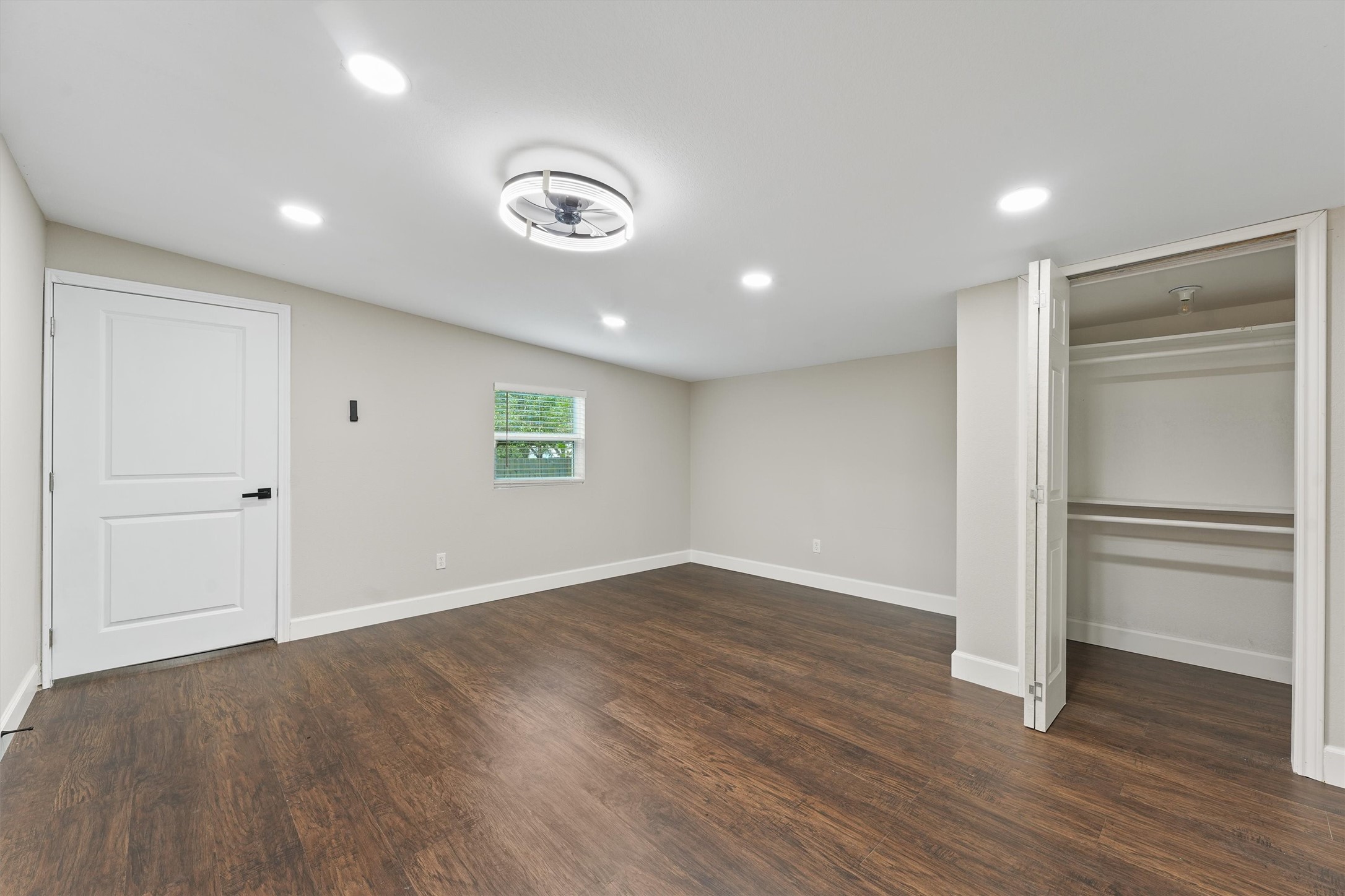 905 Franconia Drive Conroe, TX 77316 - Photo 8 of 12 an empty room with wooden floor and window