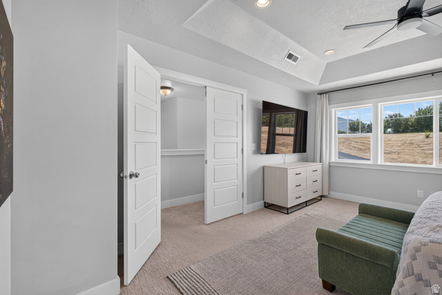 1263 East 1200th South Springville, UT 84663 - Photo 17 of 60 Recessed lighting and a ceiling fan illuminate this room featuring a tray ceiling, dual windows with exterior views, and a closet with bifold doors