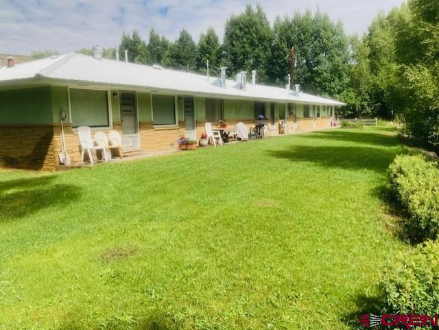 a front view of a house with a yard table and chairs
