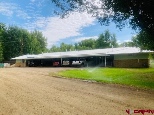 300 Bevington Road Gunnison, CO 81230 - Photo 2 of 6 a front view of a house with a yard and trees