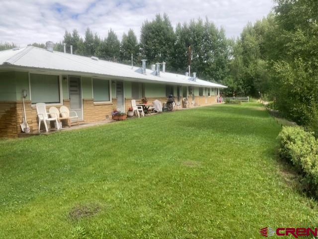 300 Bevington Road Gunnison, CO 81230 - Photo 3 of 6 a front view of a house with a garden and porch