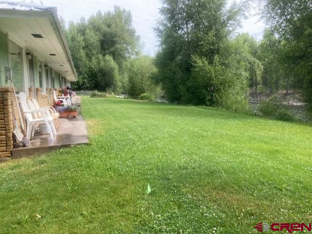 300 Bevington Road Gunnison, CO 81230 - Photo 4 of 6 a view of a patio with table and chairs a barbeque and a small yard