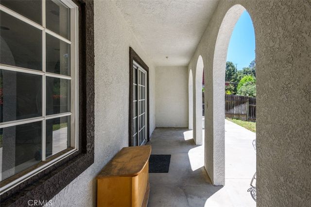 a view of backyard with small cabin and wooden fence