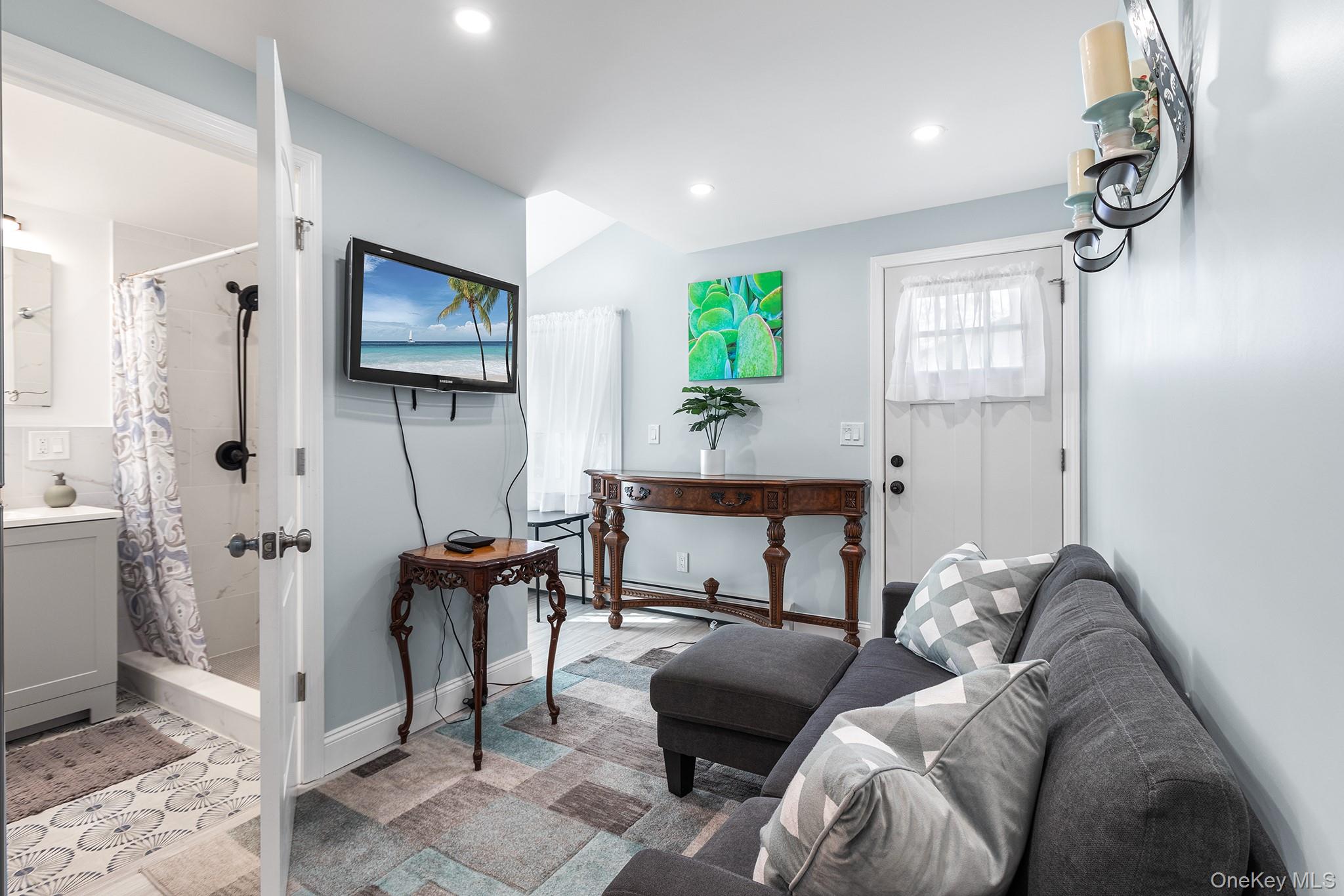 164 Colonial Springs Road Wheatley Heights, NY 11798 - Photo 17 of 35 a living room with furniture and a flat screen tv