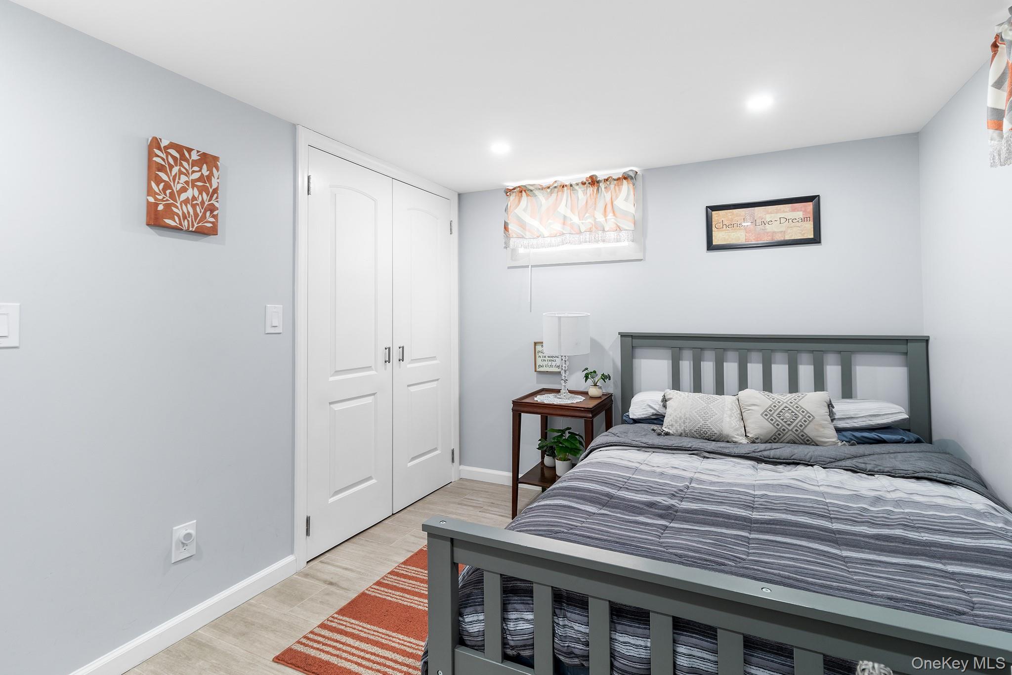 164 Colonial Springs Road Wheatley Heights, NY 11798 - Photo 19 of 35 a bedroom with a bed and a night stand