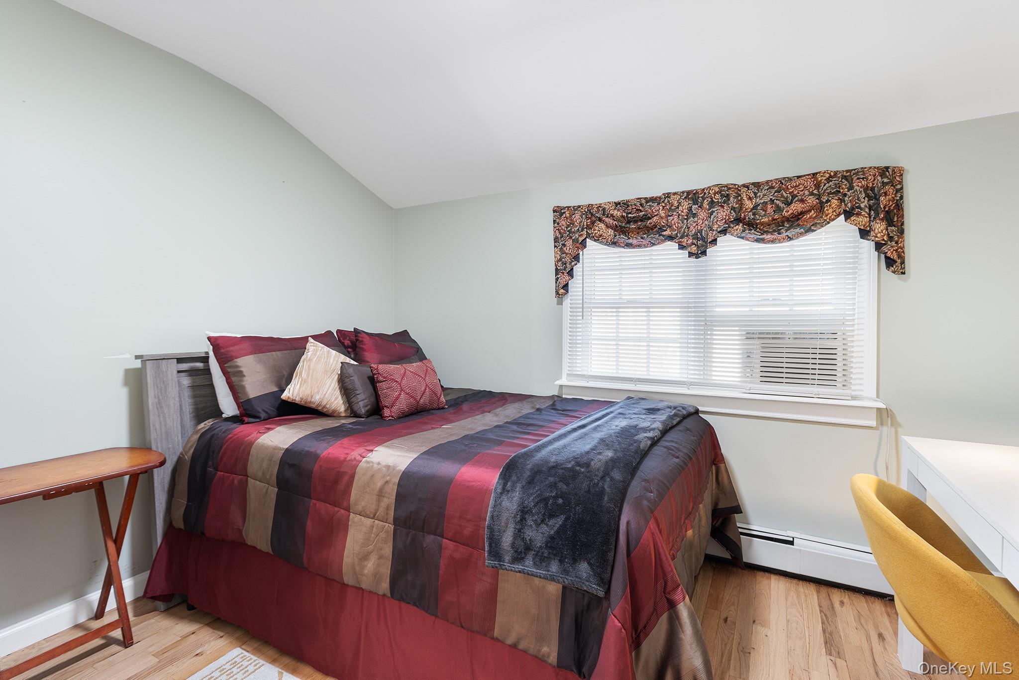 164 Colonial Springs Road Wheatley Heights, NY 11798 - Photo 20 of 35 a bedroom with a bed and wooden floor
