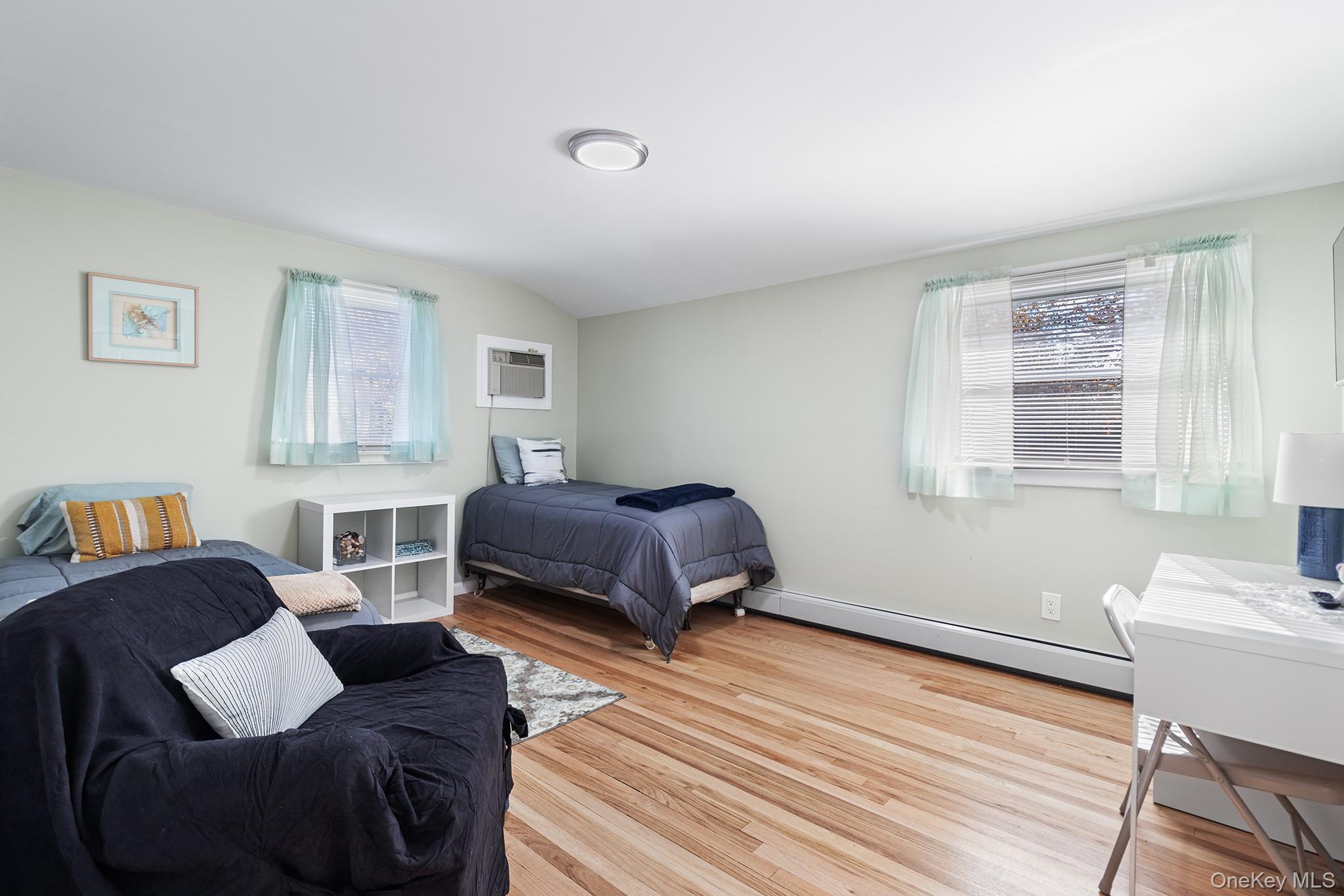 164 Colonial Springs Road Wheatley Heights, NY 11798 - Photo 21 of 35 a bedroom with a bed couch and a window
