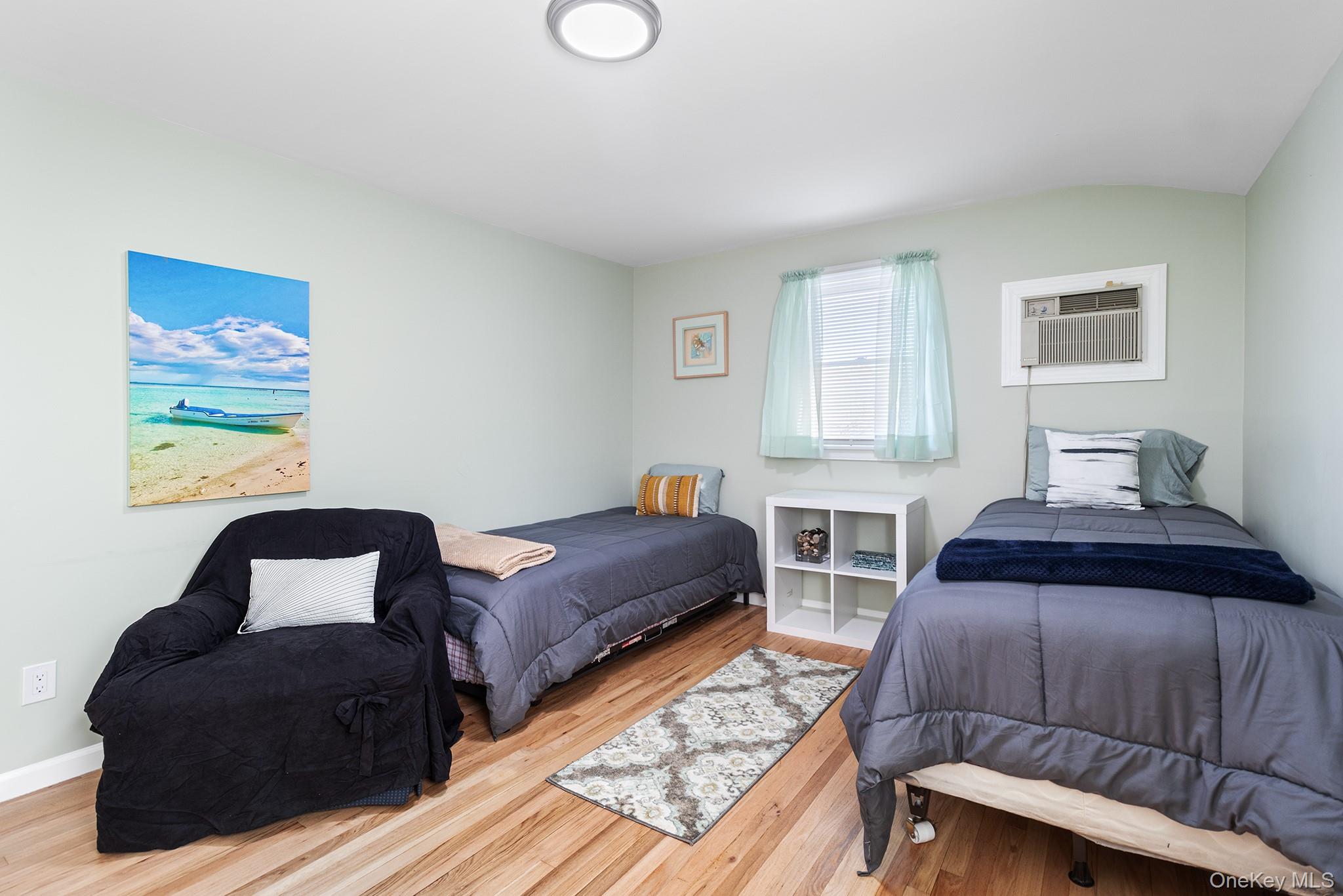164 Colonial Springs Road Wheatley Heights, NY 11798 - Photo 22 of 35 a bedroom with two beds and a window