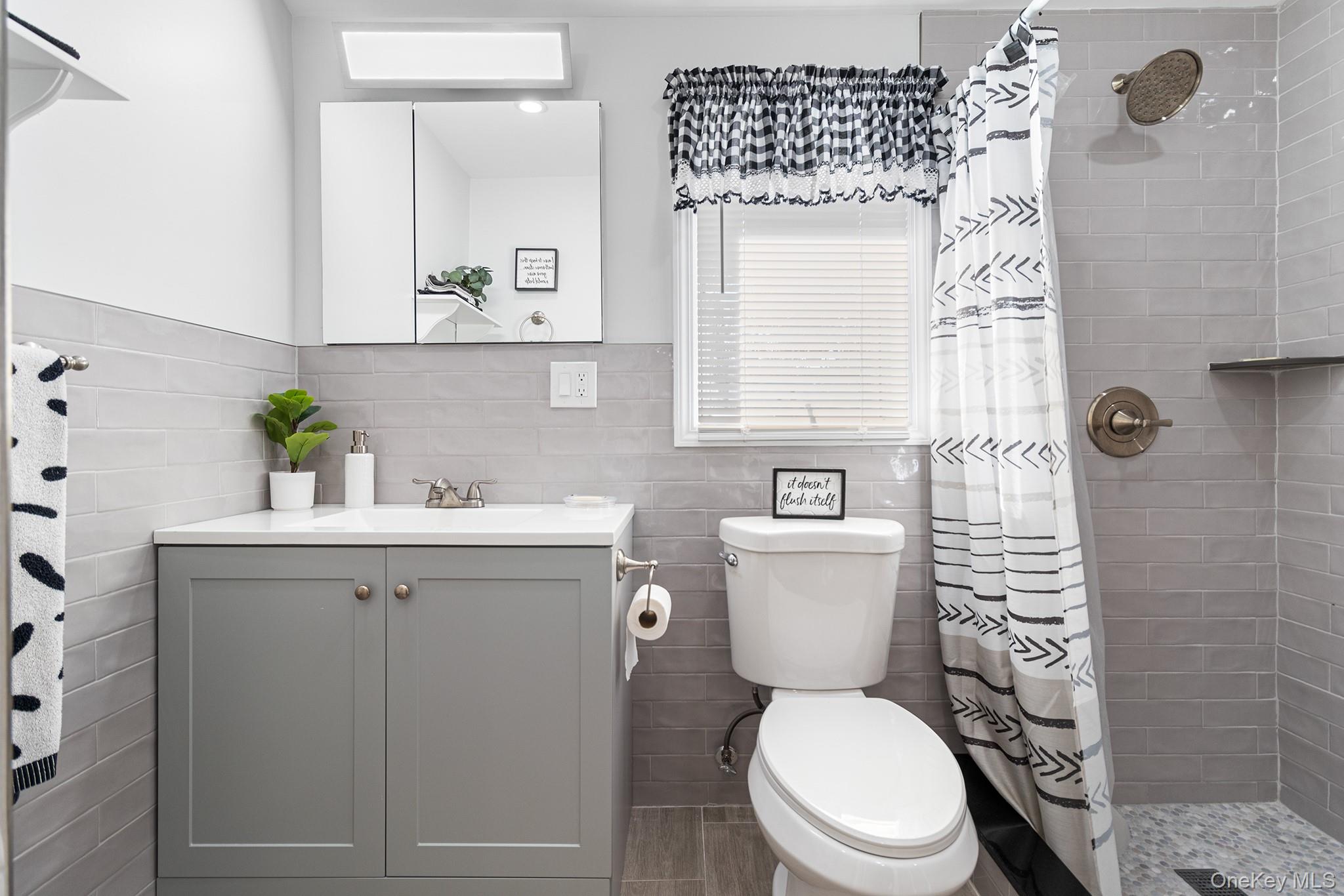 164 Colonial Springs Road Wheatley Heights, NY 11798 - Photo 24 of 35 a bathroom with a sink a toilet and shower