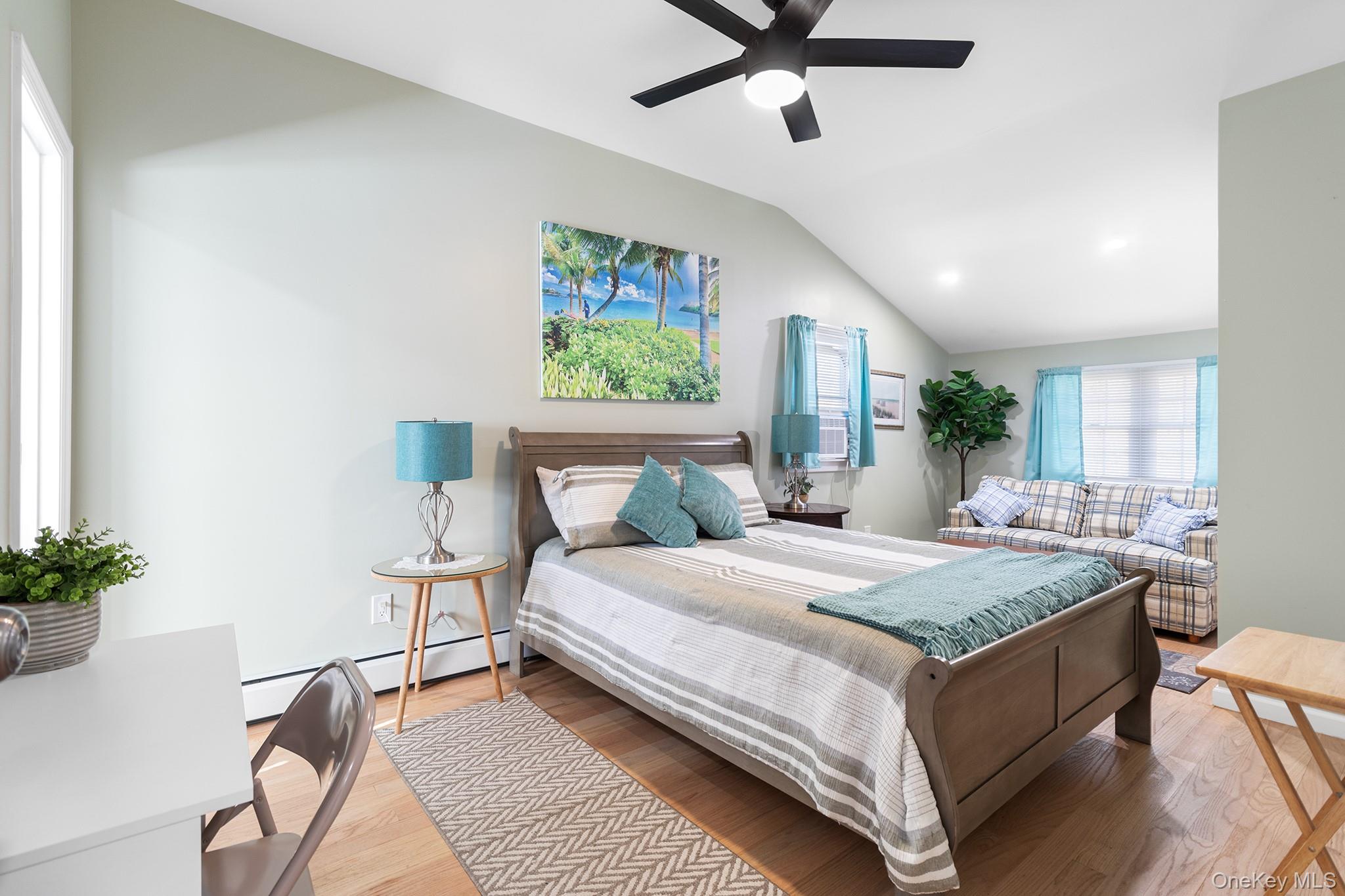 164 Colonial Springs Road Wheatley Heights, NY 11798 - Photo 25 of 35 a bedroom with a bed chandelier and a window