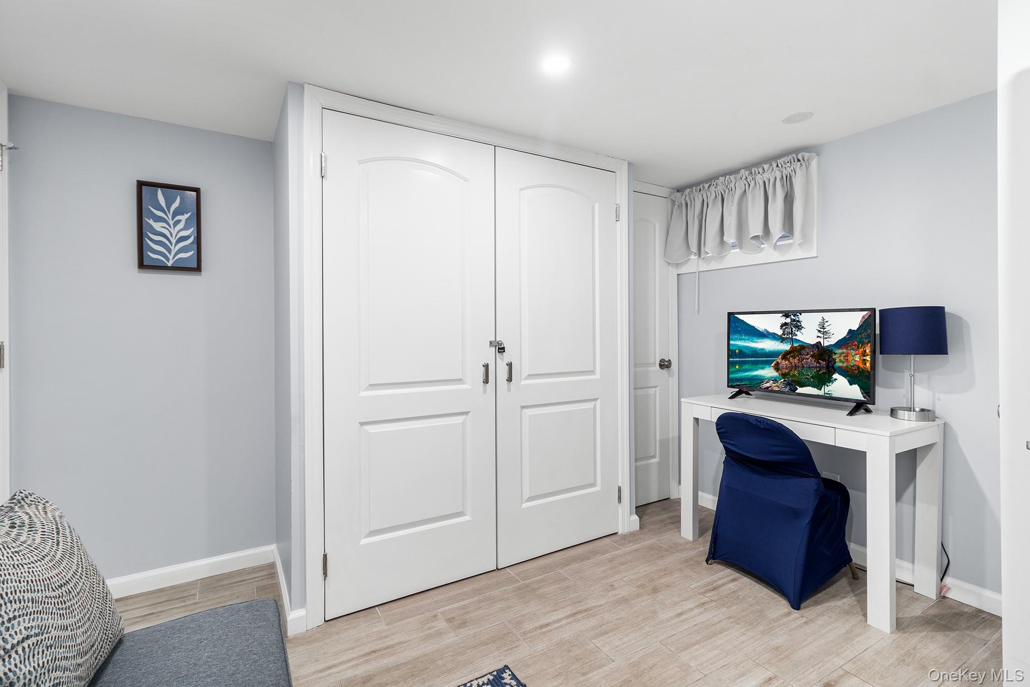164 Colonial Springs Road Wheatley Heights, NY 11798 - Photo 32 of 35 a hallway with furniture and a flat screen tv