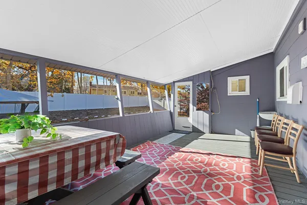 a room with a balcony a bed and furniture
