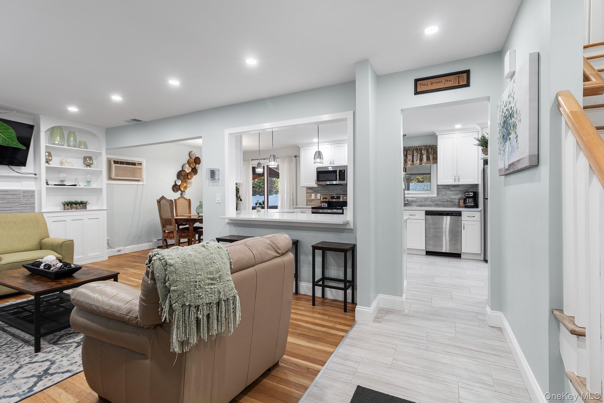 164 Colonial Springs Road Wheatley Heights, NY 11798 - Photo 7 of 35 a living room with furniture and kitchen view